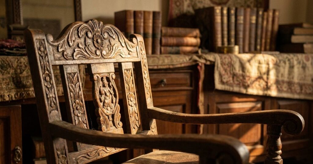 Close-up of an ornate empty wooden chair, symbolizing investment restraint, in warm light and an Indian setting.