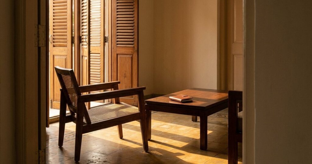 An Indian living room with sunlight filtering in, focusing on a closed checkbook to illustrate investment caution in angel investing.
