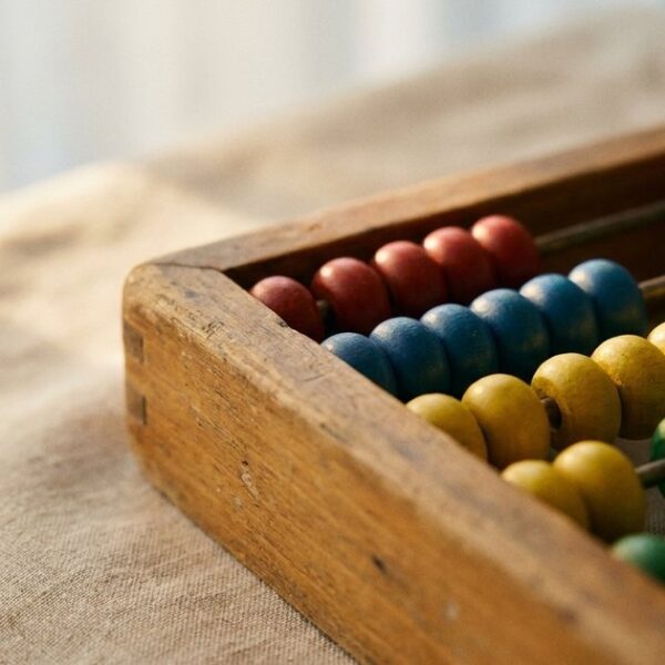 Close-up of a wooden abacus for an article on microschool design principles, highlighting learning tools.
