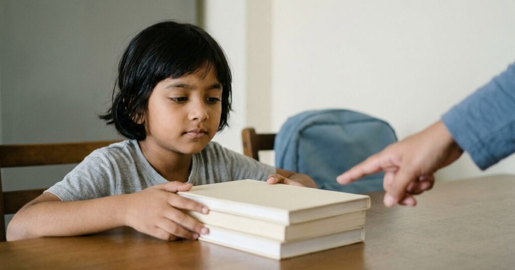 Indian child comparing school textbooks while considering CBSE, ICSE and state-board education