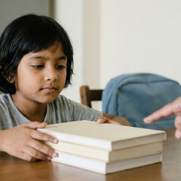 Indian child comparing school textbooks while considering CBSE, ICSE and state-board education