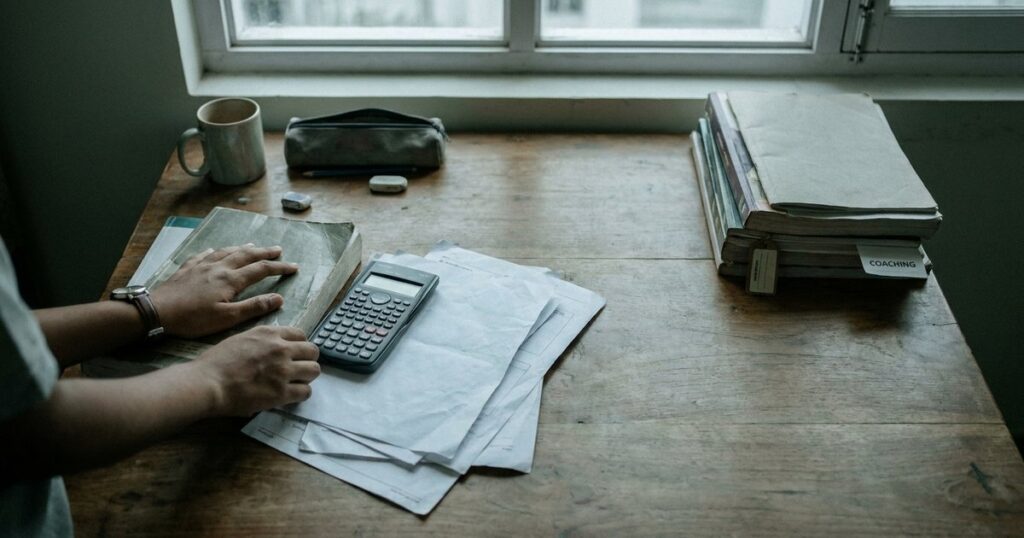 Student sorting schoolwork and coaching materials while considering whether Class 10 tuition is necessary