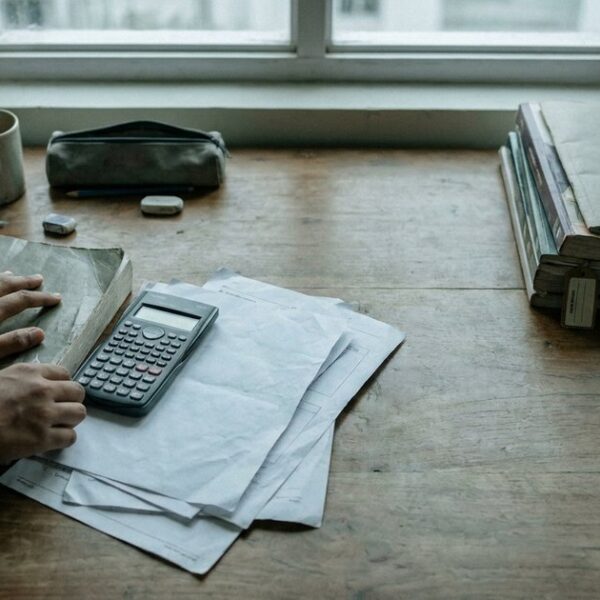 Student sorting schoolwork and coaching materials while considering whether Class 10 tuition is necessary