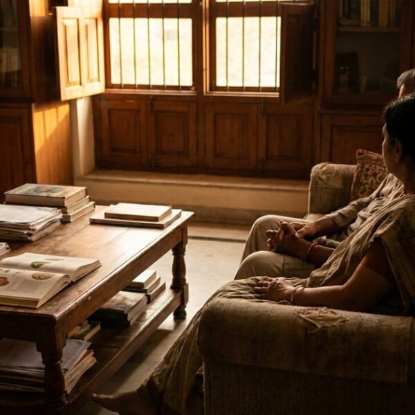 Couple in Indian home reflecting on IVF journey amid warm light, related to failed implantation and chemical pregnancy.
