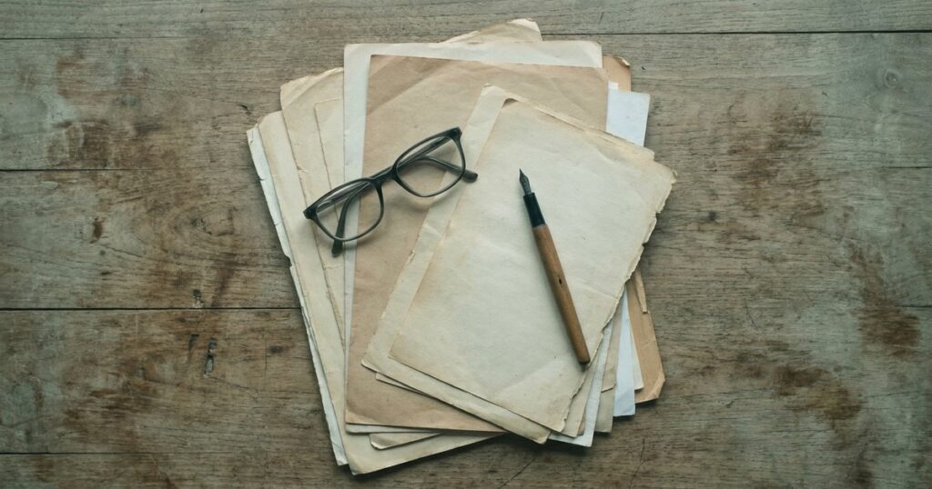 Overhead view of papers, glasses, and pen on a table related to filing an RTI First Appeal in India.