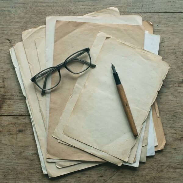 Overhead view of papers, glasses, and pen on a table related to filing an RTI First Appeal in India.