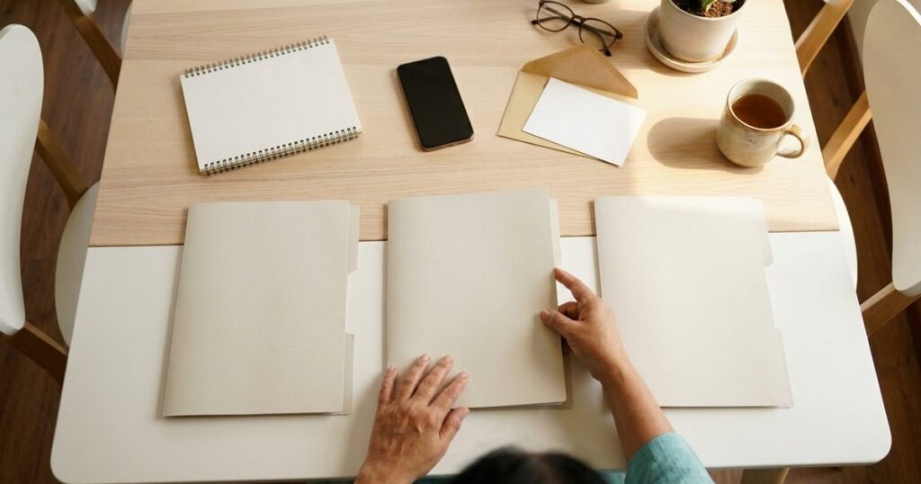 Overhead view of an Indian investor organising a 90-day investment plan on a bright wooden table
