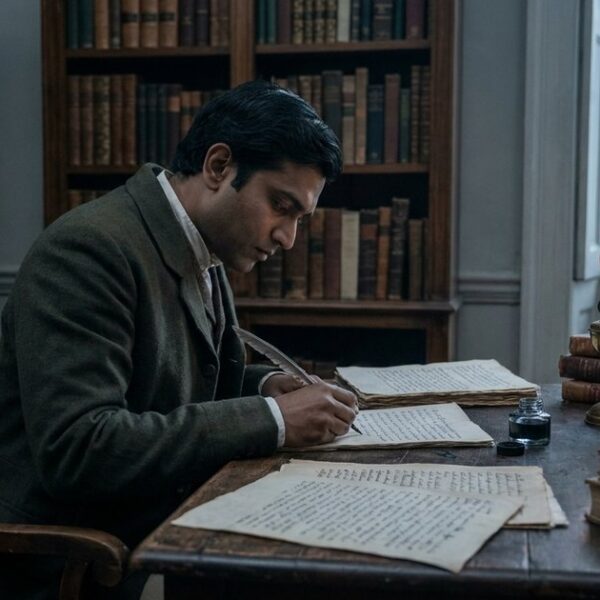 An Indian scholar from colonial times studies manuscripts, reflecting on education's historical roots in India.