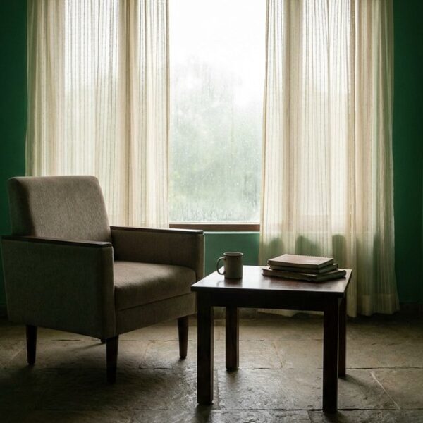 An IVF clinic consultation room, empty with monsoon-green walls and natural stone tones, highlighting patient inquiry topic.