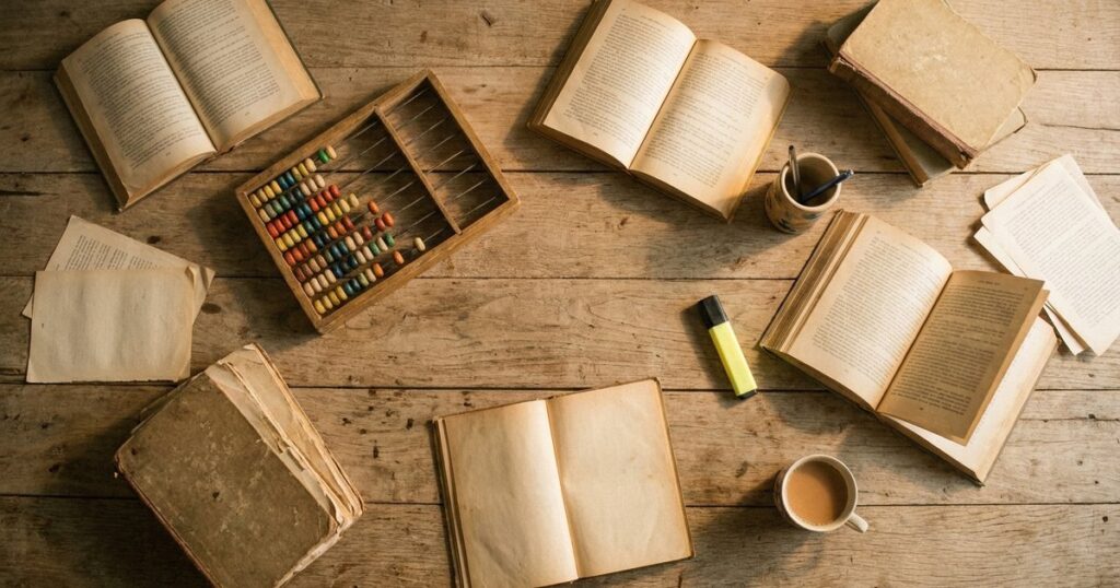 An overhead view of a cluttered table in an Indian home, symbolizing the balance between tutoring and self-directed learning.